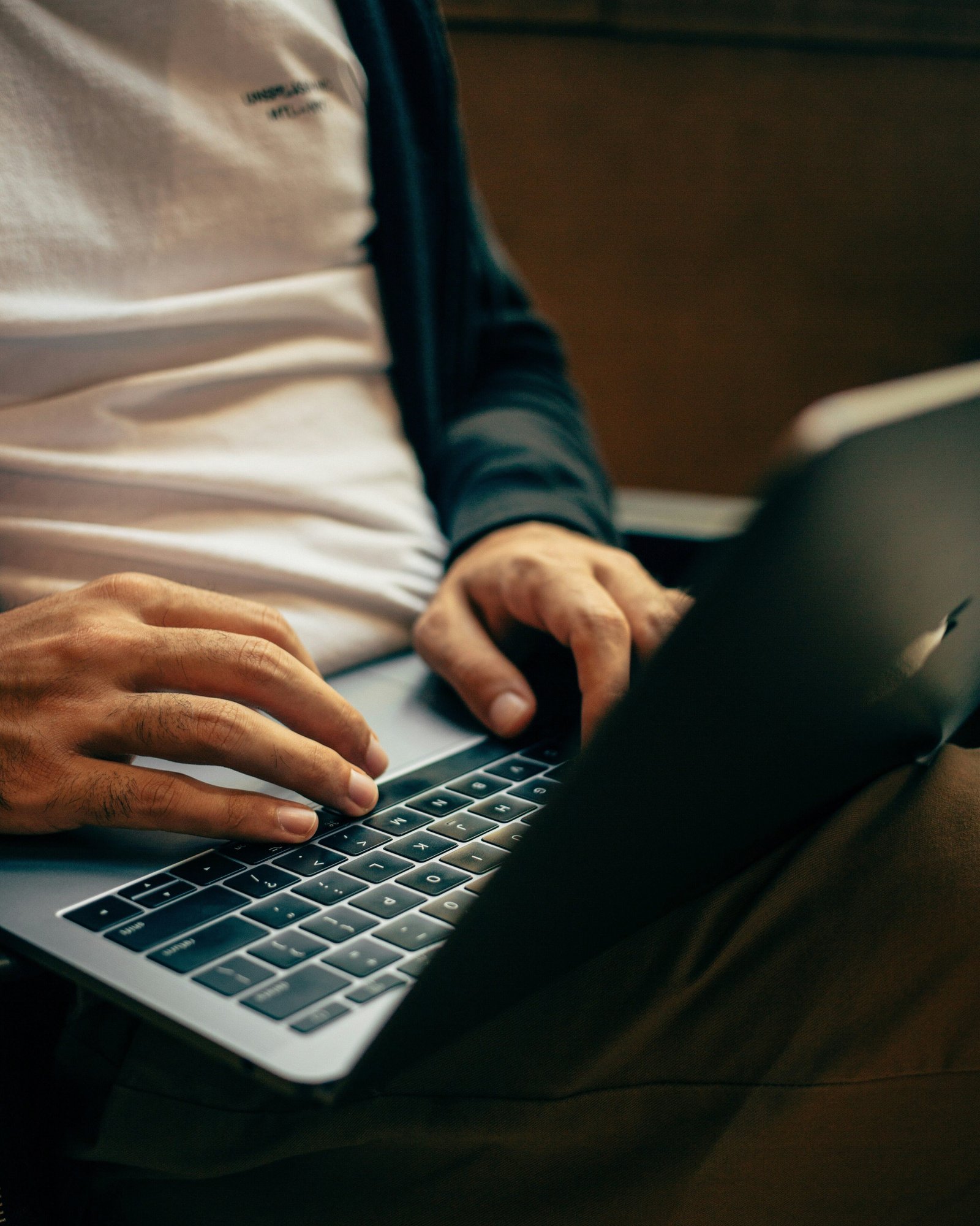 Man in T shirt using a laptop 54