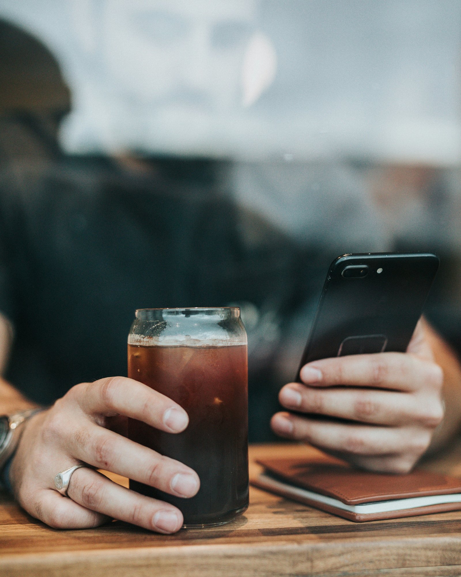 man holding coffee and phone 54